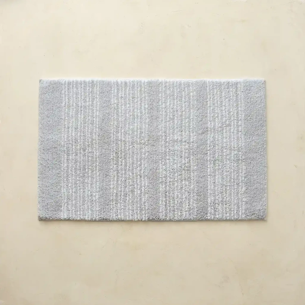Grey bathroom rug with fine white stripes