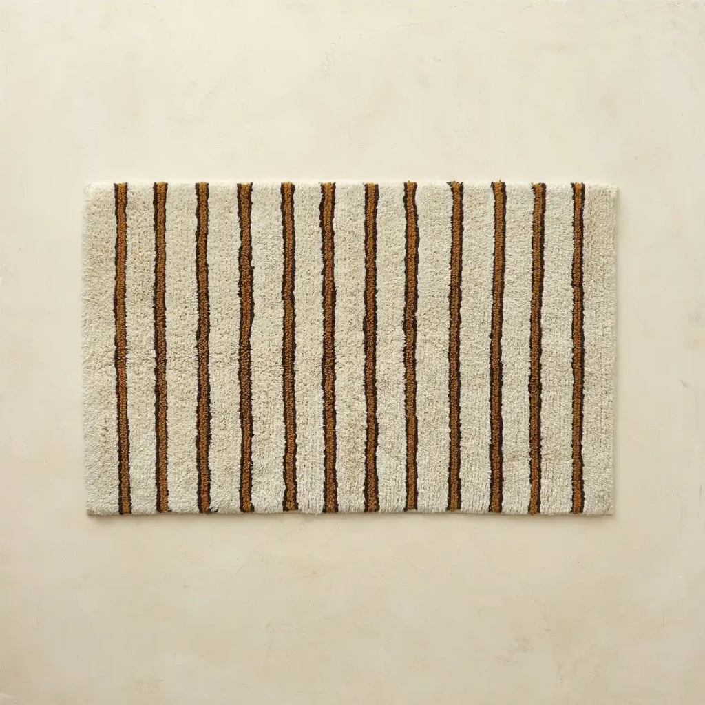Plush striped bath rug for shower and tub